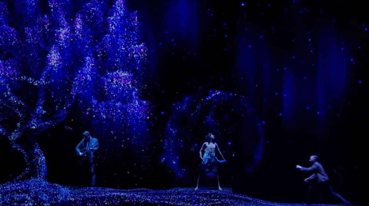 A cloud of blue particles drifting across a stage