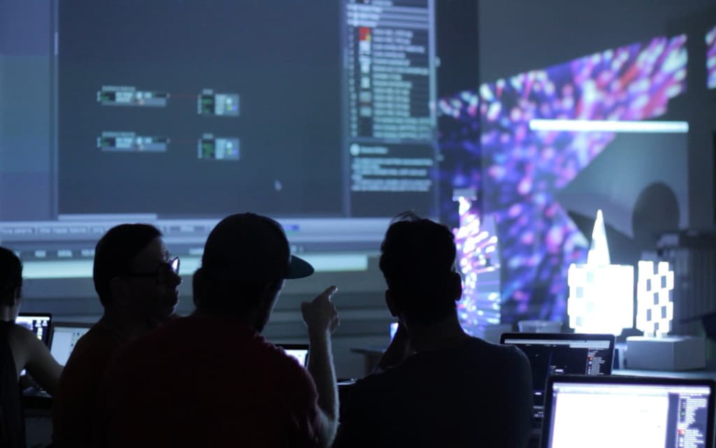 Editors working on cinematic footage in a dim suite